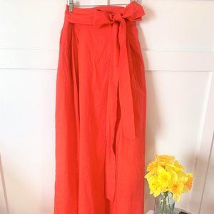High waisted, coral, floor length, silk skirt.